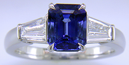 Emerald-cut Sapphire with tapered baguette diamonds in a custom platinum ring. (J8643)