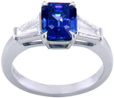 Emerald-cut Sapphire with tapered baguette diamonds in a custom platinum ring. (J8643)