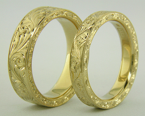 Hand engraved 18kt gold bands with flowing scrolls.