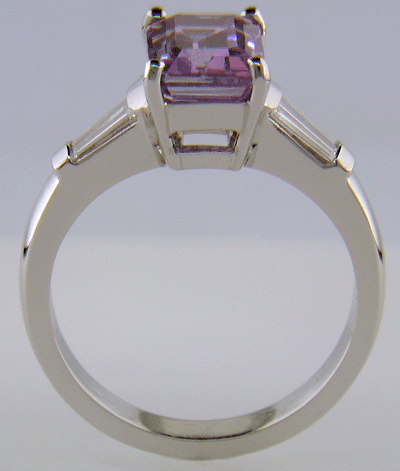 Side view of hand-crafted platinum ring with Lavender Sapphire set with tapered baguette diamonds.