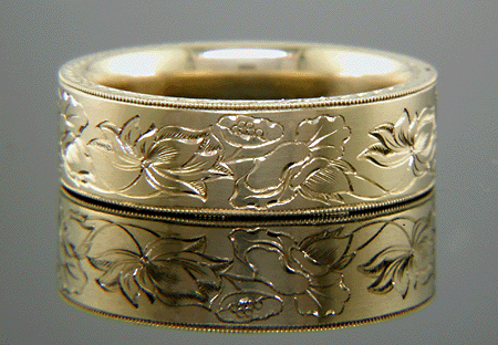 18kt gold band with hand engraved lotus blossoms.