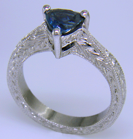 Platinum engraved ring with trillium Montana sapphire.