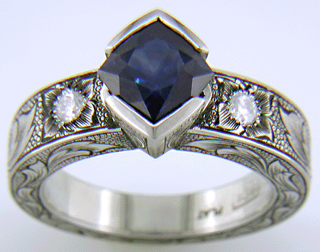 A Montana Sapphire set with diamonds in a beautifully hand-engraved platinum ring. (J7239)