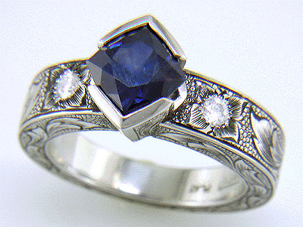 A Montana Sapphire set with diamonds in a beautifully hand-engraved platinum ring. (J7239)