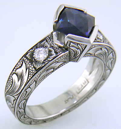 A Montana Sapphire set with diamonds in a beautifully hand-engraved platinum ring. (J7239)