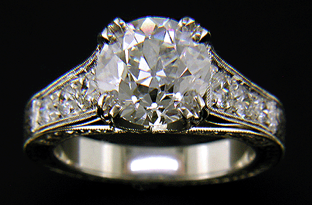 An Old European-cut diamond set with Fancy Pink diamonds in a handcrafted platinum ring.