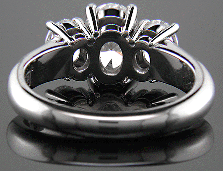 Inside view of three stone platinum ring with three oval diamonds.