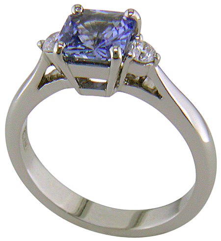 Radiant-cut sapphire set with two round diamonds in a hand-crafted platinum ring. (J8522)