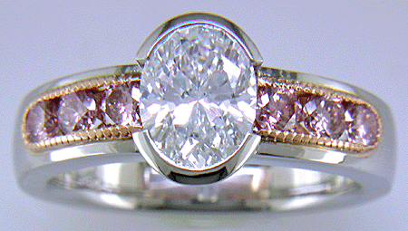 Oval Diamond set with 6 brilliant Pink Diamonds in a custom rose gold and platinum ring.