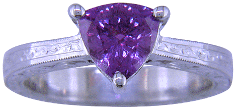 Trillium-cut purple sapphire set in a hand-engraved platinum ring.