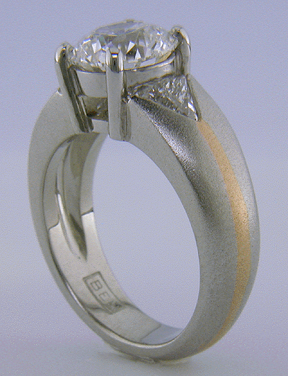 Platinum and rose gold ring with an ideal-cut diamond and trilliants.