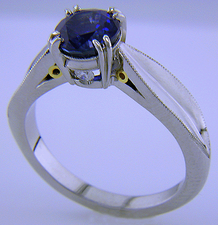 Shoulder view of sapphire ring with two hidden diamonds.