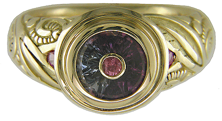 Torus-cut sapphire set in 18kt gold ring.