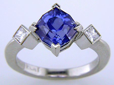 Starburst-cut sapphire set with two brilliant diamonds in a custom platinum ring.