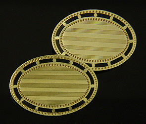 TH oval gold and black enamel cufflinks. (J8607)