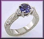 Fancy violet sapphire and diamonds set in a hand-engraved platinum ring.