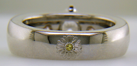 Custom platinum engagement ring with rose and green gold accents.