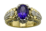 A tanzanite engagement ring with diamonds handcrafted in platinum and gold.