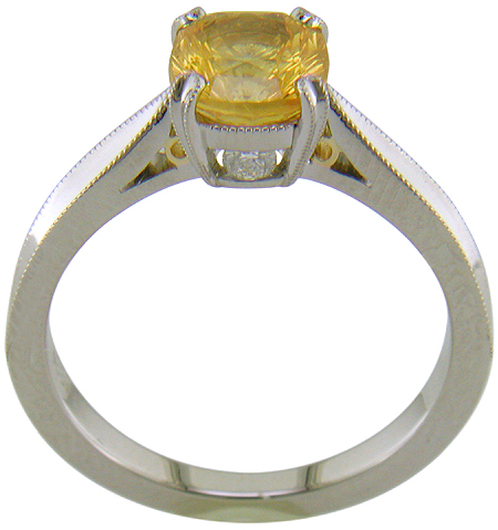 Side view of concave faceted yellow sapphire set with two hidden diamonds in a handcrafted platinum ring. (J7253)