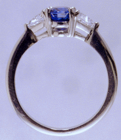 Side view of custom sapphire and diamond ring in platinum
