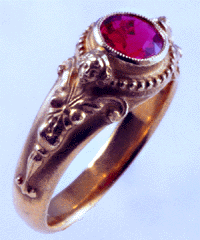 18kt gold ring with winged women and red spinel.