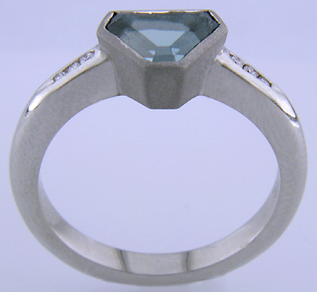 Side view of Calf-head Aquamarine with round diamonds in a custom platinum ring.