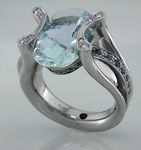 Platinum ring set with a clover-cut aquamarine, diamonds and 25 Montana sapphires.