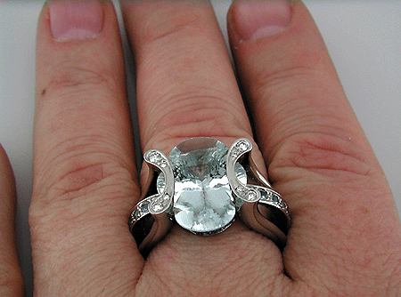 Platinum ring set with a clover-cut aquamarine, diamonds and 25 Montana sapphires.