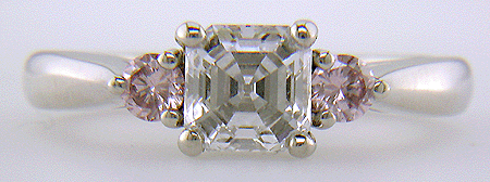 Asscher-cut diamond set with two Fancy Pink diamonds in a handcrafted platinum ring.