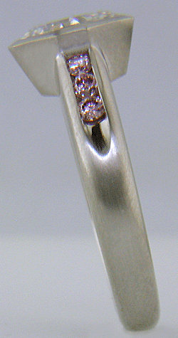 Shoulder view of an Asscher diamond set with Fancy Intense pink diamonds in a custom platinum engagement ring.