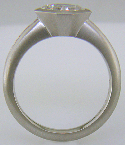 Side view of an Asscher diamond set with Fancy Intense pink diamonds in a custom platinum engagement ring.