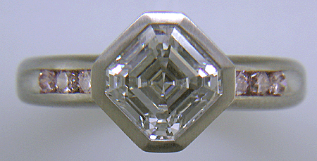 An Asscher-cut Diamond set with Fancy Intense Pink Diamonds in a custom platinum engagement ring.