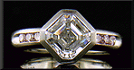An Asscher-cut Diamond set with Fancy Intense Pink Diamonds in a custom platinum engagement ring.