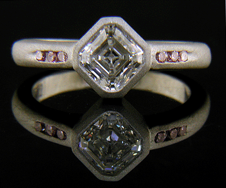 Royal Asscher diamond set with Fancy Vivid pink diamonds in a custom platinum ring.