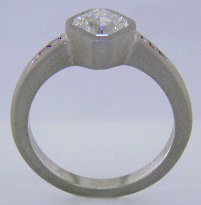 Side view of an Asscher diamond set with Fancy Intense pink diamonds in a custom platinum engagement ring.
