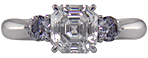 An Asscher-cut Diamond set with two Blue-Violet Round Diamonds in a hand-crafted platinum ring.