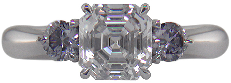 An Asscher-cut Diamond set with two Blue-Violet Round Diamonds in a handcrafted platinum ring.