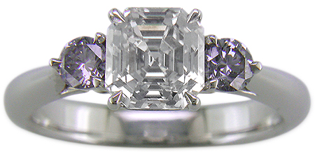 An Asscher-cut Diamond set with two Blue-Violet Round Diamonds in a handcrafted platinum ring.