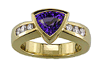 Trillium-cut tanzanite set with graduated diamonds in an 18kt gold ring.