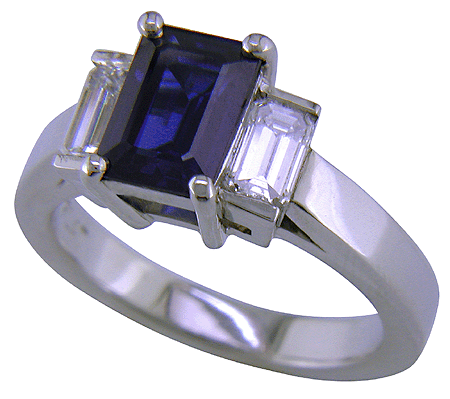 Emerald cut sapphire and diamond ring in platinum.