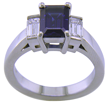Side view of emerald-cut sapphire and diamond ring.