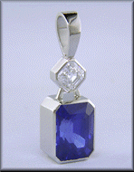 Custom platinum pendant featuring a beautiful Sapphire and an Asscher-cut Diamond.