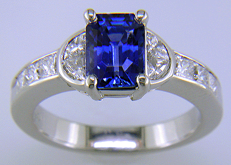 Emerald-cut sapphire and diamond ring in platinum.