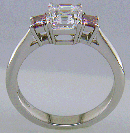 Side view handcrafted platinum ring with an Asscher-cut Diamond set with two Pink Princess-cut Diamonds.