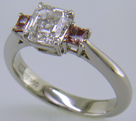 An Asscher-cut Diamond set with two Pink Princess-cut Diamonds in a handcrafted platinum ring.