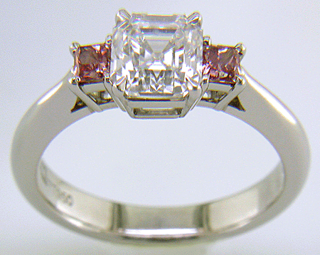 An Asscher-cut Diamond set with two Pink Princess-cut Diamonds in a handcrafted platinum ring.