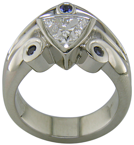 Side view of trilliant diamond ring with three small sapphires.