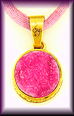 Drusy cobaltocalcite set in a 22kt gold pendant.