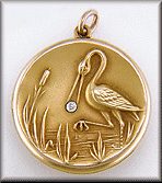 Victorian 14kt gold locket with a crane clutching a diamond in its beak. (J8639)