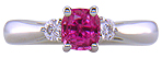 Cushion-cut Pink Sapphire set with two round diamonds in a handcrafted platinum ring.
